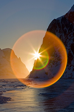 The Lindblad Expedition ship National Geographic Explorer transits Lemaire Channel in late evening light on the west side of the Antarctic peninsula in Antarctica