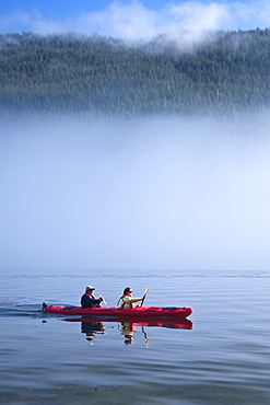 Kayaking from the Lindblad Expedition ship National Geographic Sea Lion in the fog in Tracy Arm in Southeast Alaska, USA. Pacific Ocean. No model or property release available for this photograph.