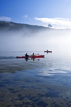 Kayaking from the Lindblad Expedition ship National Geographic Sea Lion in the fog in Tracy Arm in Southeast Alaska, USA. Pacific Ocean. No model or property release available for this photograph.