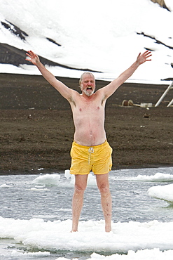 Lindblad Expeditions guests doing the "polar Plunge" in Port Foster near Whalers Bay inside the caldera on Deception Island, South Shetland Island Group, Antarctica. NO MODEL RELEASES FOR THIS IMAGE.