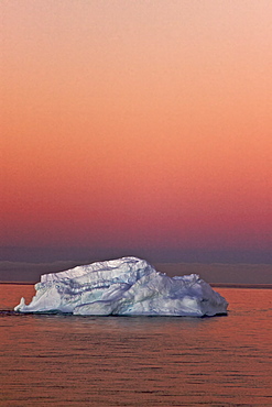 The Lindblad Expedition ship National Geographic Explorer in late evening light as the sun sets in the northwest side of the Antarctic Peninsula in Antarctica. 