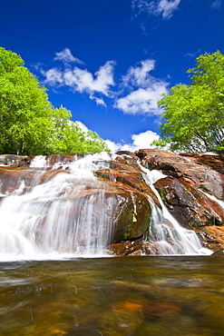 A beautiful waterfall just outside the small Norwegian summer area in Sandvika Bay on the south side of Svesfjord, Norway.