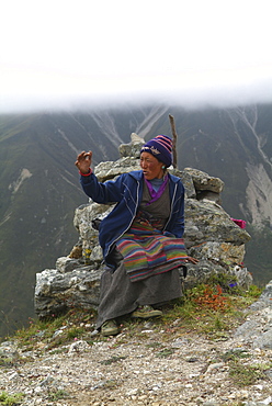 Tibetan Lady.  Mountain and Clouds.Traditional Dress,  Himalayas, Tibet.