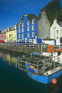 Creel boat by Tobermory's multi-coloured Main Street.  Hebrides, Scotland   (RR)